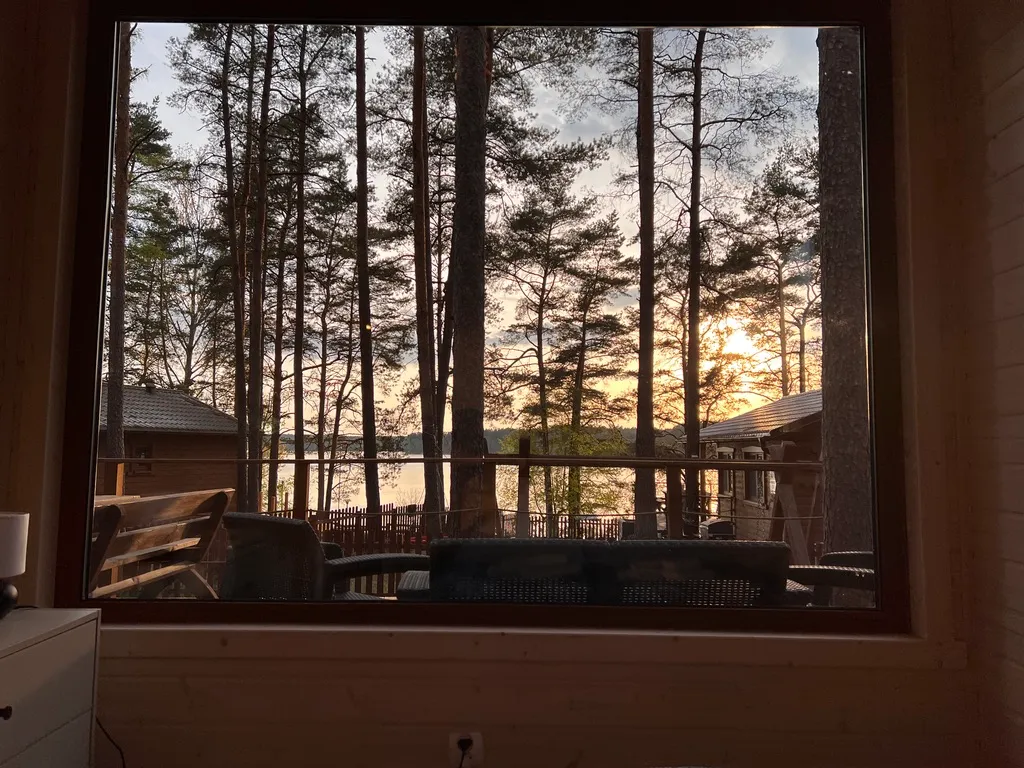 View from the Forest cabin bedroom: sunset over the lake between the pines