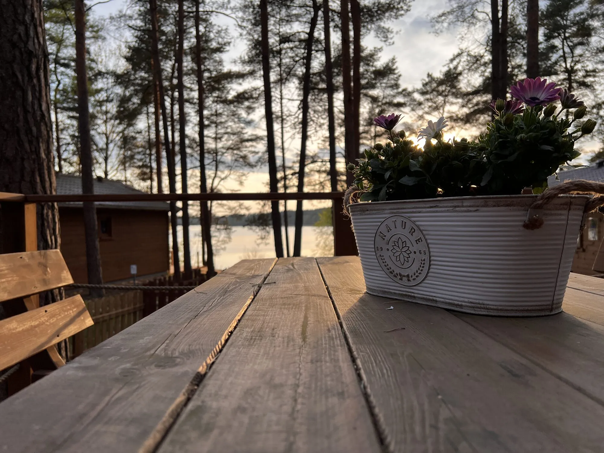 Sunset over Lake Wdzydze seen from the table on the Forest cabin terrace
