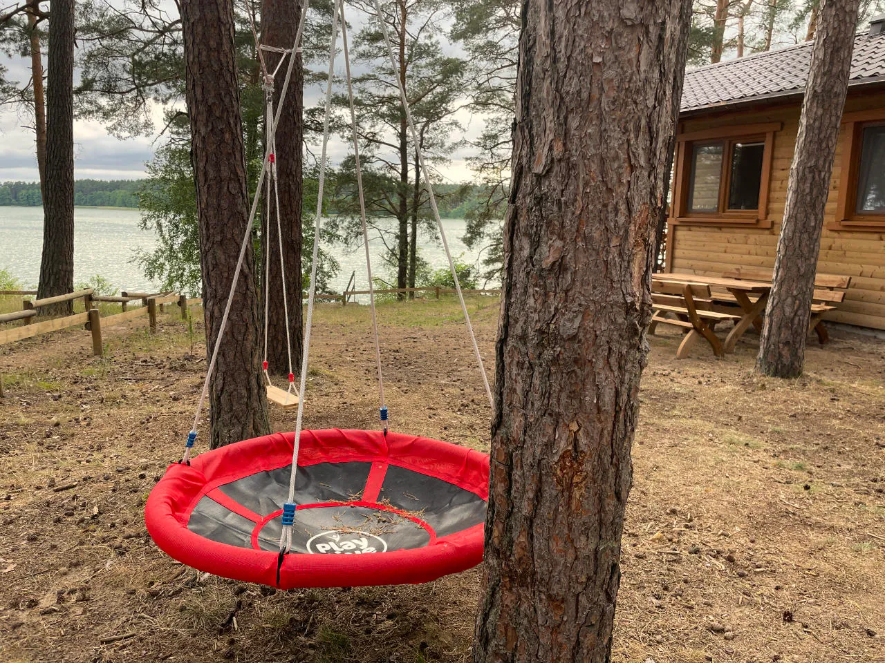 Nest swing for children on the Panorama cabin plot by the lake
