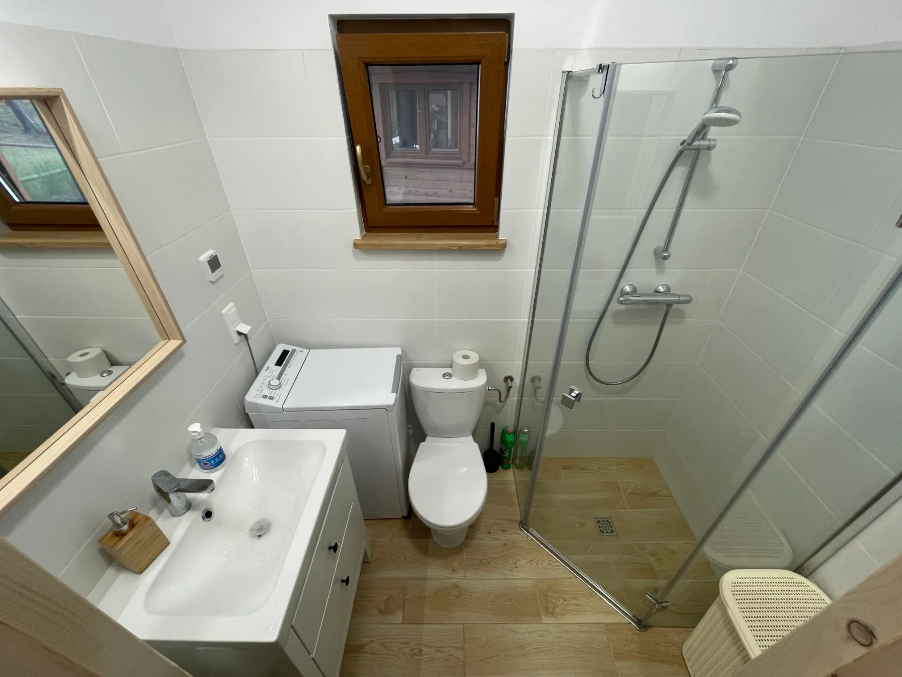 Bathroom with shower and washing machine in the Panorama cabin